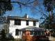 View of home exterior highlighting brick sunroom and window trim at 322 E Houston St, Monroe, NC 28112