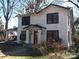 Charming two-story home with black window frames and a covered front porch at 322 E Houston St, Monroe, NC 28112