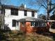 Two-story home with visible window frames and a brick sun room at 322 E Houston St, Monroe, NC 28112