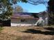 Garage with an unkempt roof and a large amount of dead leaves covering it at 322 E Houston St, Monroe, NC 28112