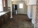 Kitchen with stainless steel refrigerator and brick accent wall detail at 322 E Houston St, Monroe, NC 28112