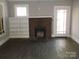 Living room with an old fireplace and old floors at 322 E Houston St, Monroe, NC 28112