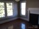 Living room with hardwood floors, fireplace and multiple windows for natural light at 322 E Houston St, Monroe, NC 28112