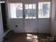 Sunroom has white brick walls and windows with a door leading outside at 322 E Houston St, Monroe, NC 28112