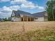The backyard features a covered porch and an expansive yard, perfect for outdoor living and entertaining at 4024 Landsford Rd, Marshville, NC 28103