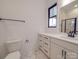 Bright bathroom with modern fixtures featuring white vanity with drawers, black pulls, and a large mirror at 4024 Landsford Rd, Marshville, NC 28103