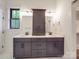 Bathroom featuring a double sink vanity with black cabinets and white countertop, and large mirror at 4024 Landsford Rd, Marshville, NC 28103