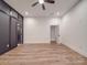Spacious bedroom with hardwood floors, ceiling fan, recessed lights, closet, and open doorway at 4024 Landsford Rd, Marshville, NC 28103