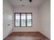 Bright bedroom featuring hardwood floors, a window with black trim, and a double door closet at 4024 Landsford Rd, Marshville, NC 28103