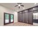 Bedroom featuring black accent wall, wood floors, glass doors to backyard, and attached bathroom at 4024 Landsford Rd, Marshville, NC 28103