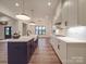 This spacious kitchen has a large island with a sink and a view into the dining room at 4024 Landsford Rd, Marshville, NC 28103