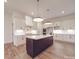 The kitchen features white cabinets, stainless steel appliances, a large island, and modern pendant lighting at 4024 Landsford Rd, Marshville, NC 28103