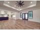 Open-concept living room with a tray ceiling, access to the kitchen, and doors to the backyard at 4024 Landsford Rd, Marshville, NC 28103