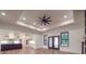 Open-concept living room with access to the kitchen, tray ceiling, and doors to the backyard at 4024 Landsford Rd, Marshville, NC 28103