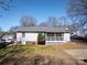 Exterior view of the home with a fenced backyard and a small patio at 403 Easy St, Concord, NC 28027