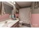 Charming bathroom with a vanity, toilet, and shower with white curtain at 403 Easy St, Concord, NC 28027