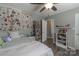 Inviting bedroom with a ceiling fan, wood-look floors, and an open doorway at 403 Easy St, Concord, NC 28027