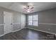 Bedroom showcasing wood-look floors, fresh gray paint, and a window at 403 Easy St, Concord, NC 28027