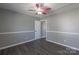 Bedroom with wood-look flooring, freshly painted walls, and a ceiling fan at 403 Easy St, Concord, NC 28027