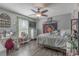 Cozy bedroom with a ceiling fan, wood-look floors, and natural light at 403 Easy St, Concord, NC 28027