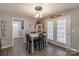 Cozy dining room with wooden floors, a white table, and farmhouse decor at 403 Easy St, Concord, NC 28027