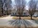 Cozy single-story home with a well-manicured lawn and mature trees lining the street at 403 Easy St, Concord, NC 28027