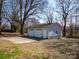 Two-car detached garage featuring a spacious driveway and a fenced yard at 403 Easy St, Concord, NC 28027