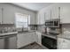 Well-equipped kitchen featuring stainless steel appliances, granite countertops, and modern white cabinetry at 403 Easy St, Concord, NC 28027
