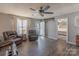 Comfortable living room featuring hardwood floors, a ceiling fan, and plenty of natural light at 403 Easy St, Concord, NC 28027
