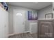 Functional mud room with white door, storage cabinets, and modern washer dryer at 403 Easy St, Concord, NC 28027