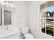 Bright bathroom with a white sink, toilet, and a window showing the outside at 4115 Kellybrook Dr, Concord, NC 28025