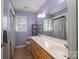 Bathroom featuring dual sinks, tile floor, and large mirror at 4301 Old Forge Dr, Gastonia, NC 28056