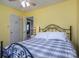 Bright bedroom with yellow walls featuring a metal bed frame and natural light at 4301 Old Forge Dr, Gastonia, NC 28056