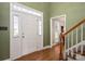 The entryway boasts hardwood floors, a staircase, and natural light streaming through sidelight windows at 4301 Old Forge Dr, Gastonia, NC 28056