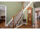 Staircase with wooden accents and adjacent grandfather clock at 4301 Old Forge Dr, Gastonia, NC 28056