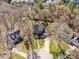 An aerial shot showcases a landscaped yard and traditional brick home in a tree-lined neighborhood at 4522 Pendock Ct, Charlotte, NC 28226