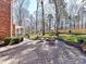 Beautiful backyard with a brick patio, a fire pit, some furniture and green grass at 4522 Pendock Ct, Charlotte, NC 28226