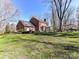 Wide shot of the backyard including the patio, the house and some trees at 4522 Pendock Ct, Charlotte, NC 28226