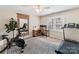 This bedroom features a treadmill, stationary bicycle, desk, and a light fixture with a fan at 4522 Pendock Ct, Charlotte, NC 28226