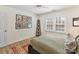 Well lit bedroom with a large window, light colored walls and colorful artwork at 4522 Pendock Ct, Charlotte, NC 28226