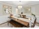 Formal dining room with wainscoting, large dining table with seating for six, and elegant decor at 4522 Pendock Ct, Charlotte, NC 28226