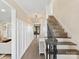 Bright foyer with wood-look floors, decorative wainscoting and staircase leading to upper level at 4522 Pendock Ct, Charlotte, NC 28226