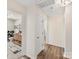 Bright hallway showcasing views into the bathroom featuring geometric tile flooring and wood vanity at 4522 Pendock Ct, Charlotte, NC 28226