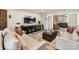 Cozy living room with modern furnishings, neutral colors, and French doors leading to sunroom at 4522 Pendock Ct, Charlotte, NC 28226