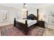 Relaxing and luxurious bedroom featuring a canopy bed, ceiling fan and decorative area rug at 4522 Pendock Ct, Charlotte, NC 28226