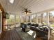 Relaxing outdoor porch with comfortable seating, ceiling fan and views to the outdoor yard at 4522 Pendock Ct, Charlotte, NC 28226