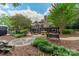 Large backyard with lush greenery, stone path, and outdoor kitchen at 4531 Montibello Dr, Charlotte, NC 28226