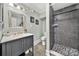 Modern bathroom featuring a single sink vanity, shower with dark tiling, and grey flooring at 4531 Montibello Dr, Charlotte, NC 28226