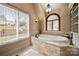 Bathroom featuring a soaking tub, and a large window at 4531 Montibello Dr, Charlotte, NC 28226