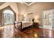 Spacious bedroom featuring hardwood floors, a large window, and an ensuite bathroom at 4531 Montibello Dr, Charlotte, NC 28226